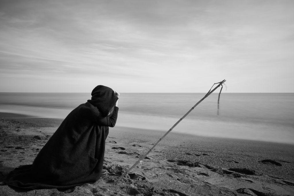 person near seashore grayscale photo 2174627